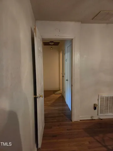 a view of a room with wooden floor and windows