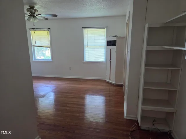 a view of storage and utility room with closet window