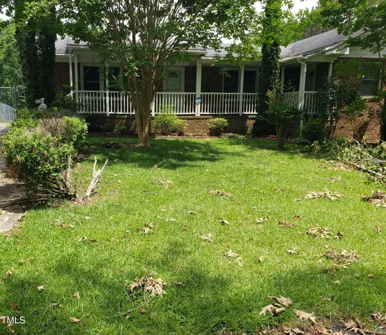 a view of a backyard with plants and a garden