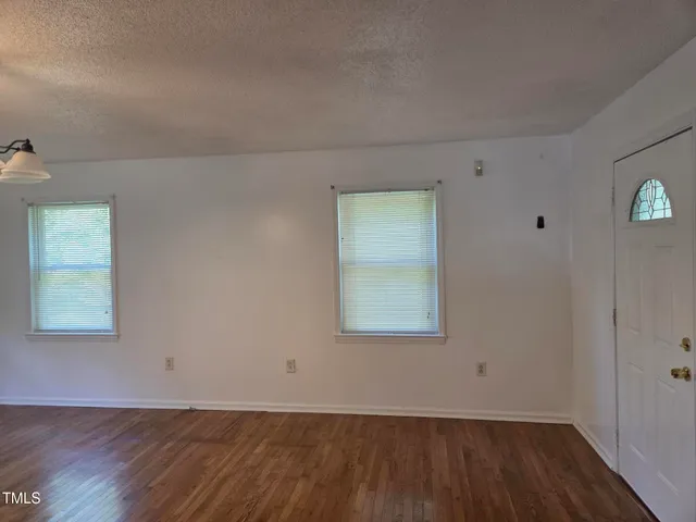 a view of house with backyard and garden