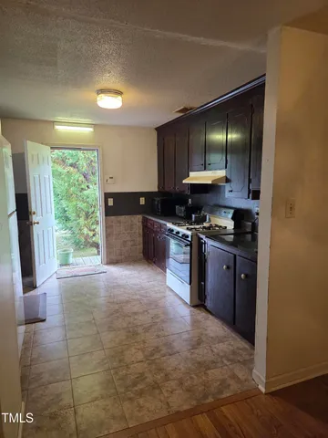 a kitchen with a sink stove and refrigerator