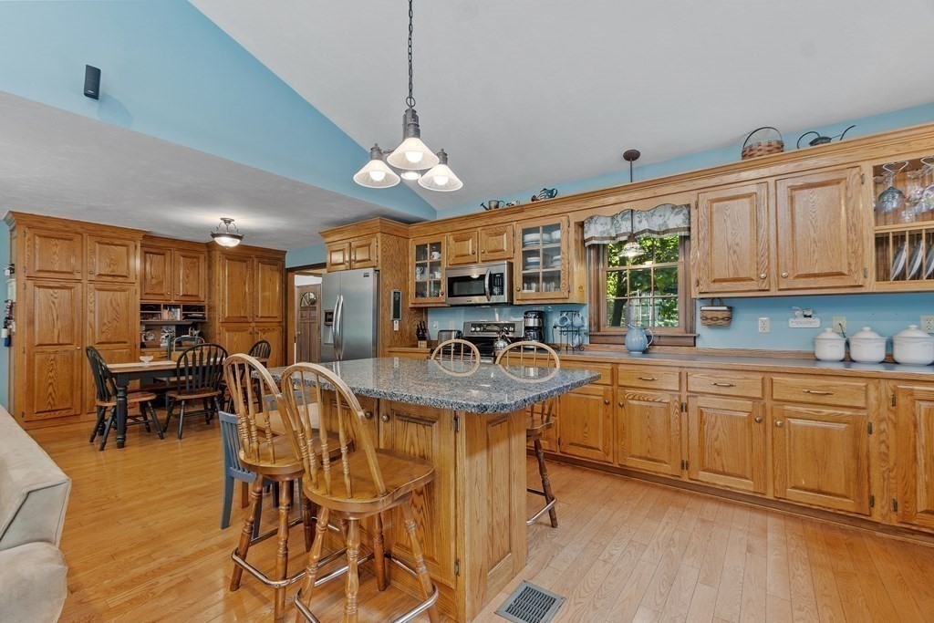 77 Turner Road Townsend, MA 01469 - Photo 17 of 34 a view of a kitchen with kitchen island granite countertop wooden floor and stainless steel appliances