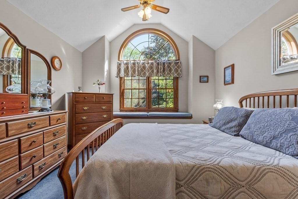 77 Turner Road Townsend, MA 01469 - Photo 24 of 34 a bedroom with a bed and a chandelier