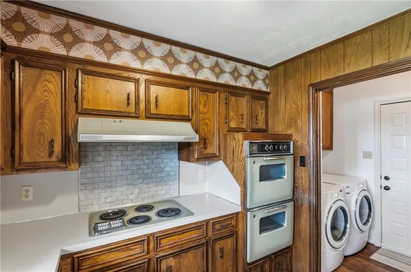 a kitchen with stainless steel appliances granite countertop a stove and a refrigerator