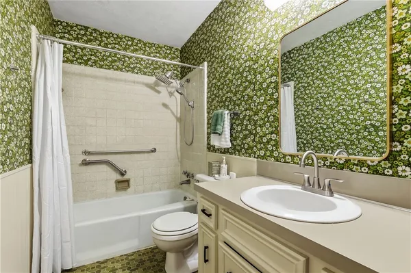 a bathroom with a sink toilet and shower