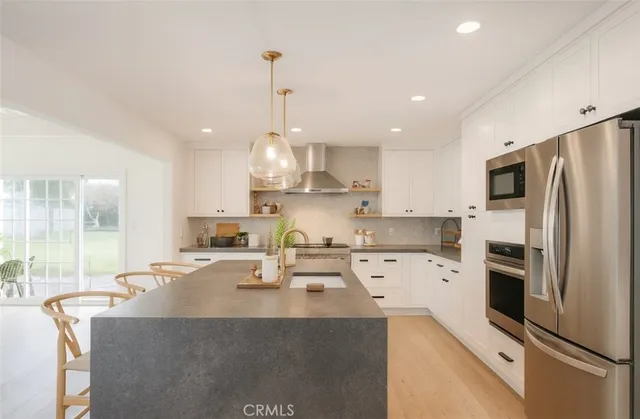 a kitchen with refrigerator and window