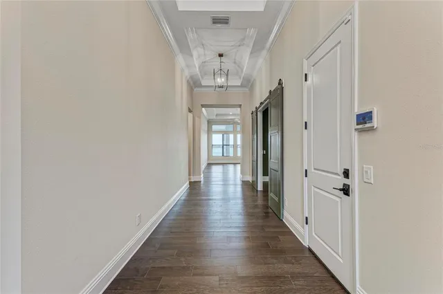 a large kitchen with granite countertop a large counter top a sink and stainless steel appliances