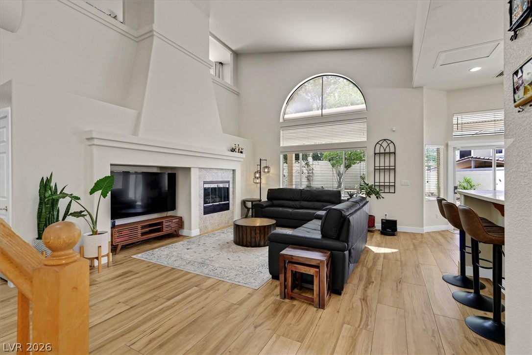 1259 Moon Vision Street Henderson, NV 89052 - Photo 5 of 53 A striking fireplace anchors this generous living room, offering an inviting focal point for gatherings.
