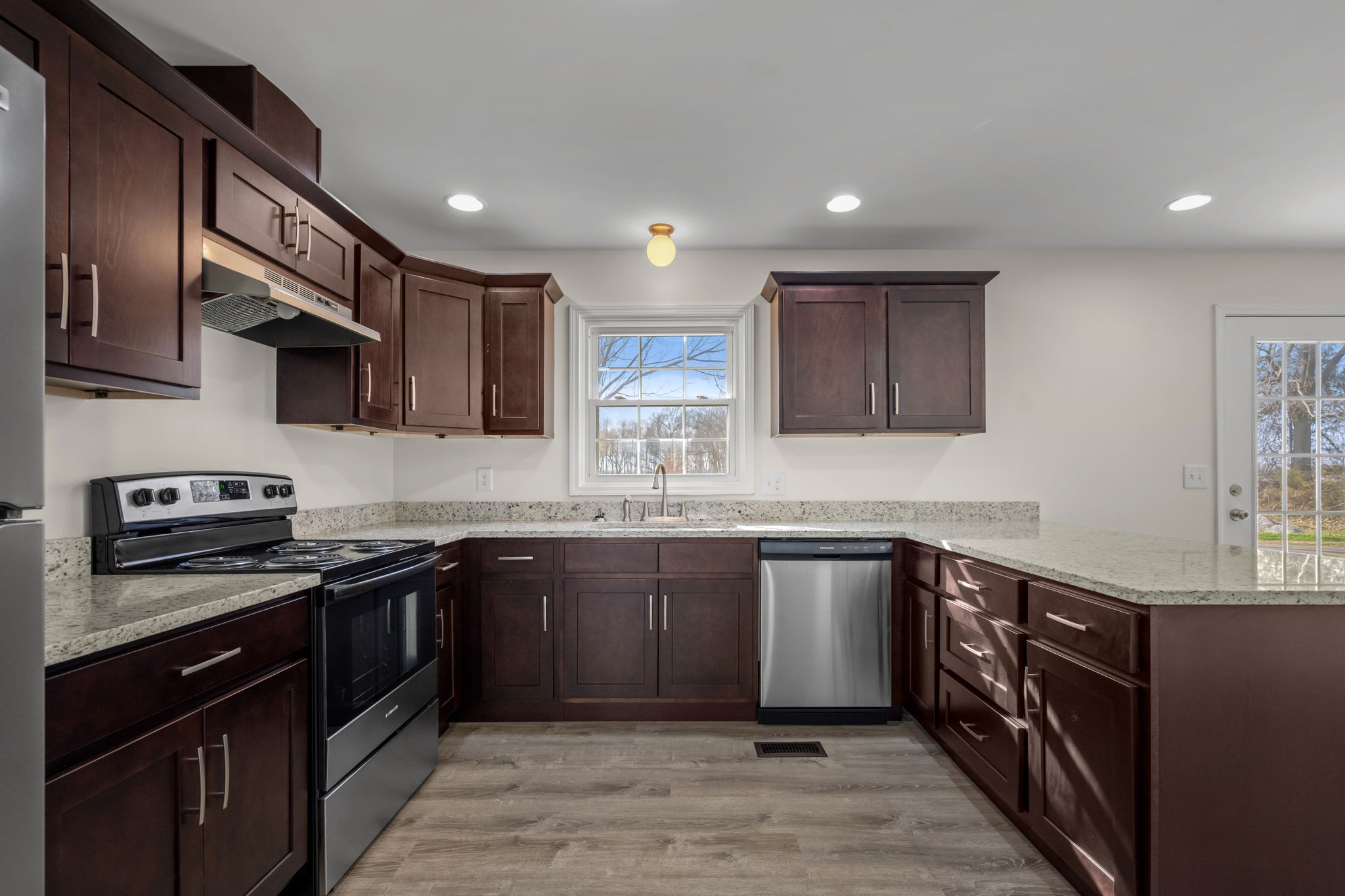 456 Whites Gap Road Huntland, TN 37345 - Photo 11 of 35 a kitchen with stainless steel appliances granite countertop wooden cabinets a sink a stove and a refrigerator
