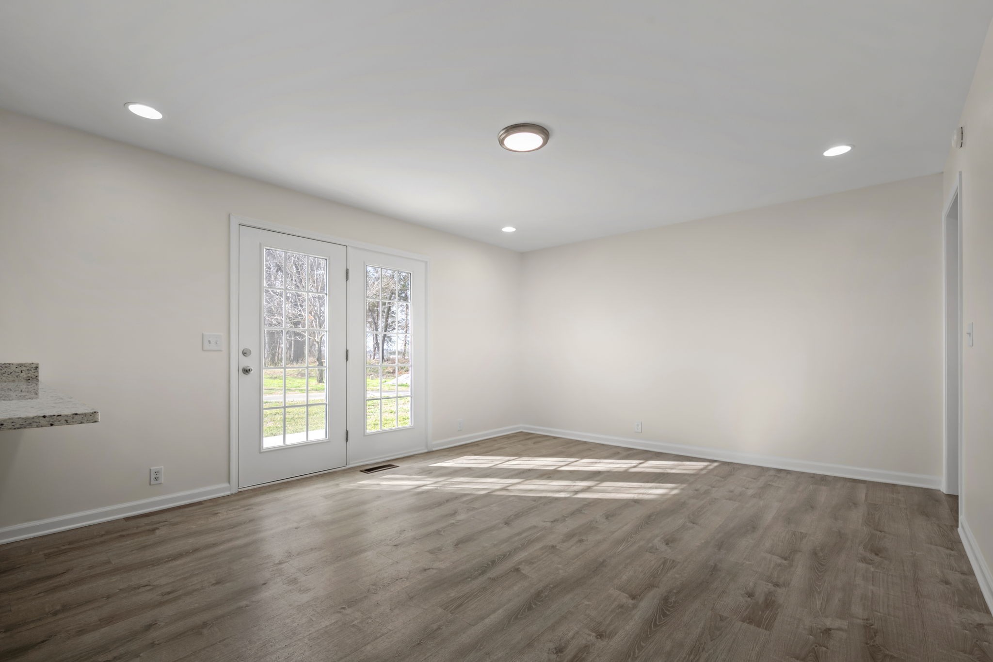 456 Whites Gap Road Huntland, TN 37345 - Photo 13 of 35 an empty room with wooden floor and windows