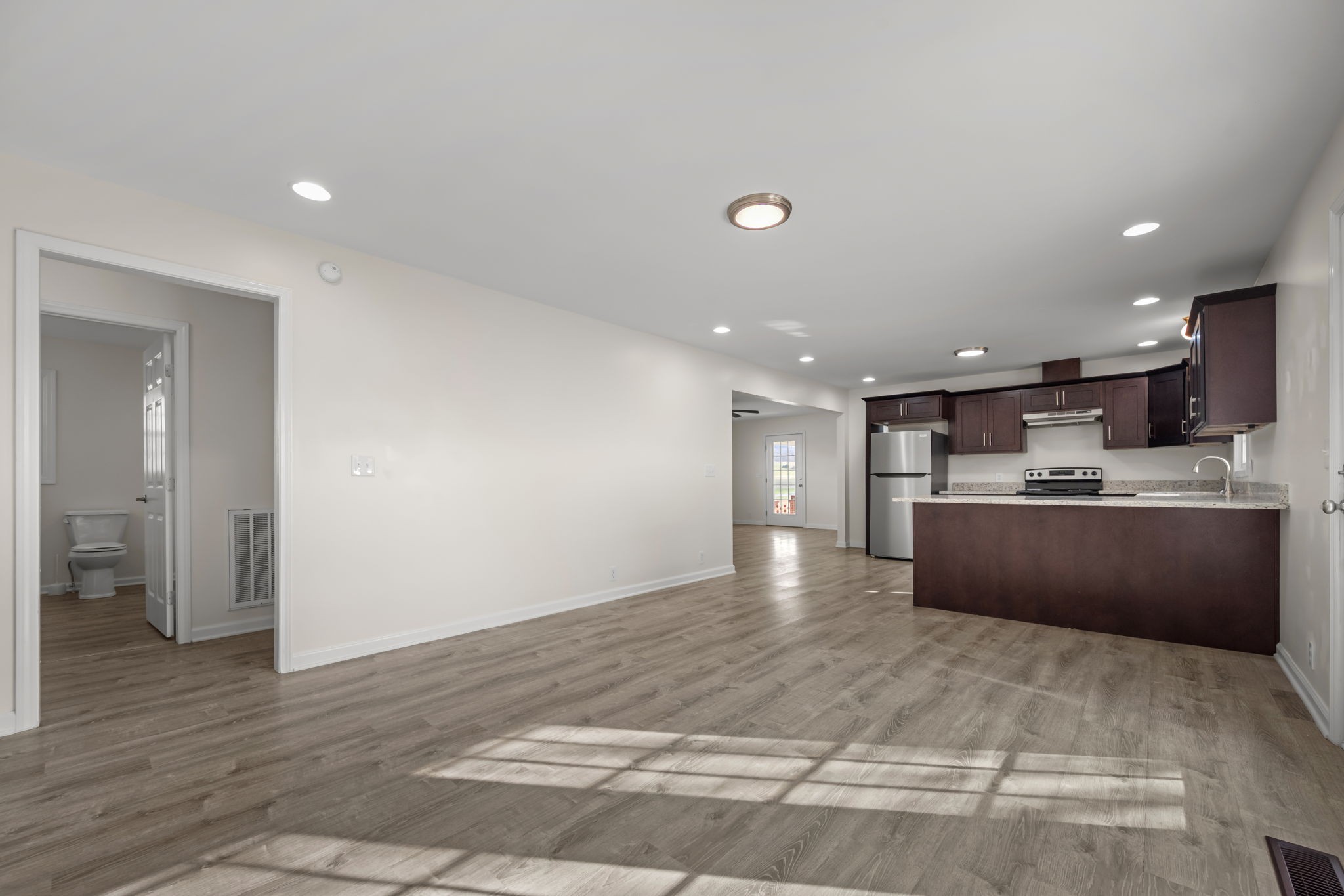 456 Whites Gap Road Huntland, TN 37345 - Photo 14 of 35 a view of kitchen with refrigerator sink and wooden floor