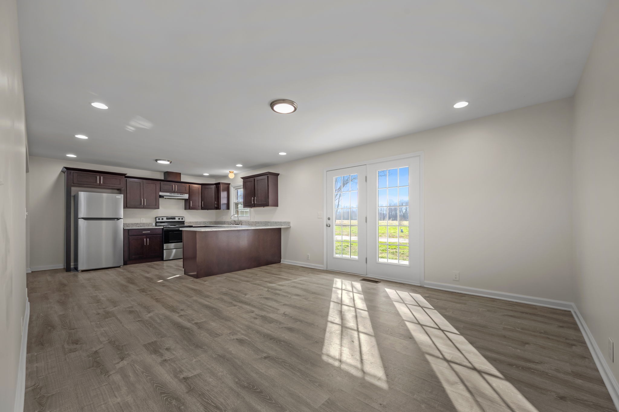 456 Whites Gap Road Huntland, TN 37345 - Photo 15 of 35 a kitchen with stainless steel appliances a refrigerator and a wooden floor