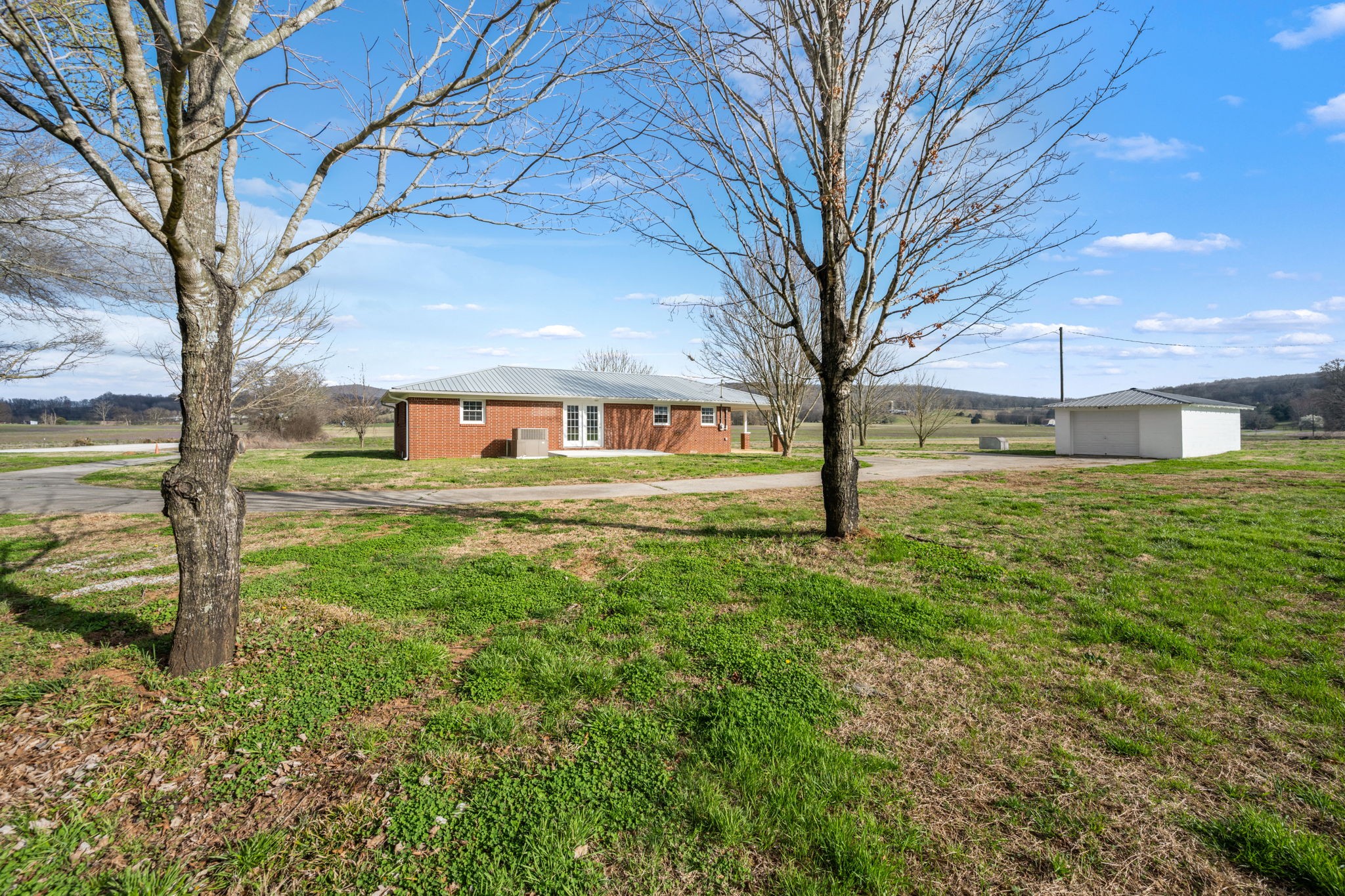 456 Whites Gap Road Huntland, TN 37345 - Photo 24 of 35 a view of a yard with plants and large trees