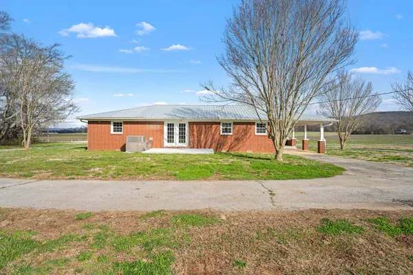 a front view of a house with a yard and a garage