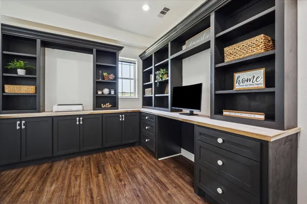 a kitchen with stainless steel appliances kitchen island granite countertop a refrigerator and a stove top oven