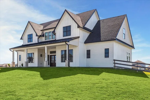 a view of a house with a yard and deck