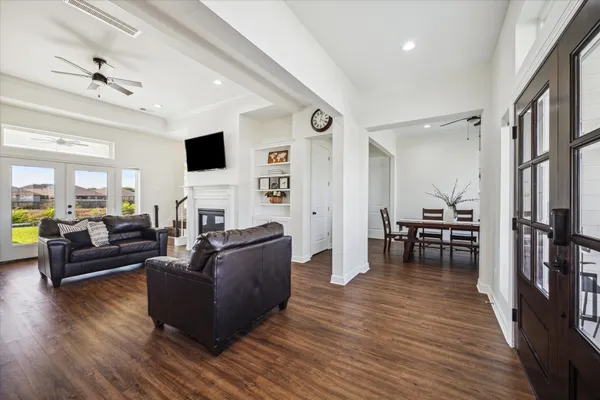 a living room with furniture and a wooden floor