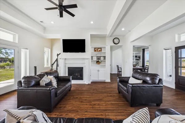a living room with furniture fireplace and flat screen tv