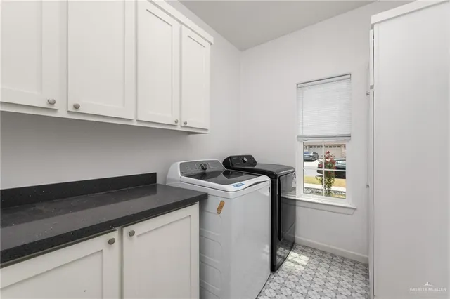 a utility room with sink dryer and washer