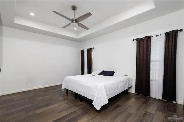 a bedroom with a bed and a large window