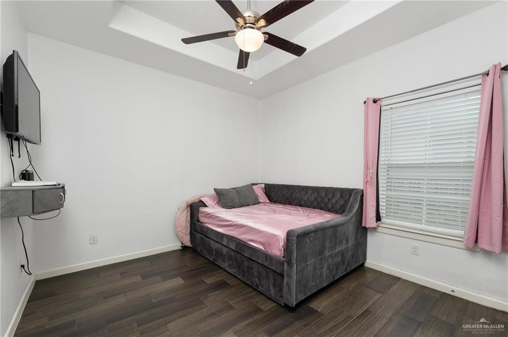405 Scarlett Red Harlingen, TX 78552 - Photo 8 of 15 a bedroom with a bed and a flat screen tv