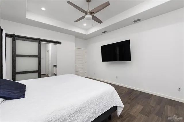 a bedroom with a bed and a flat screen tv