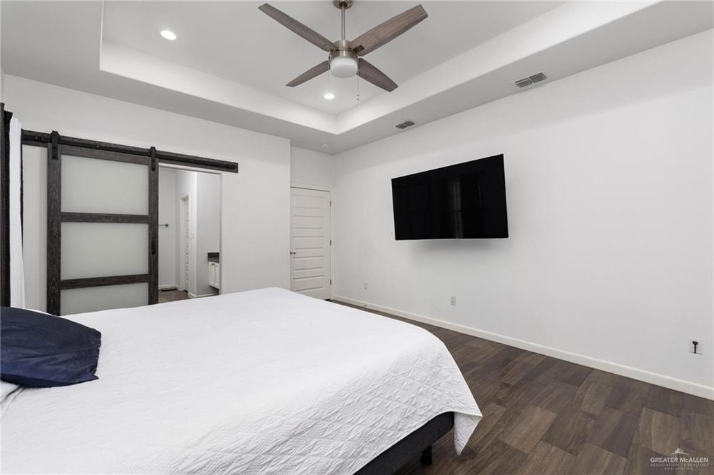 405 Scarlett Red Harlingen, TX 78552 - Photo 9 of 15 a bedroom with a bed and a flat screen tv