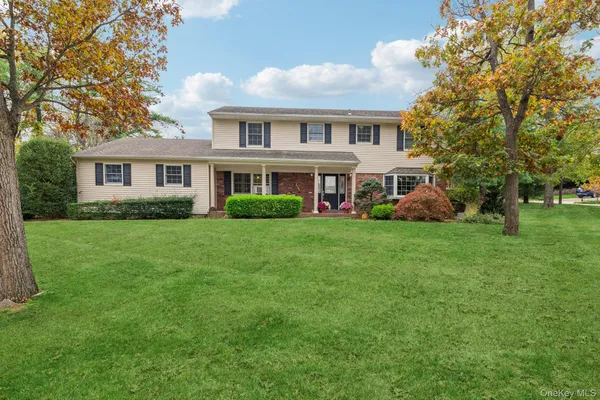 a front view of house with yard and green space
