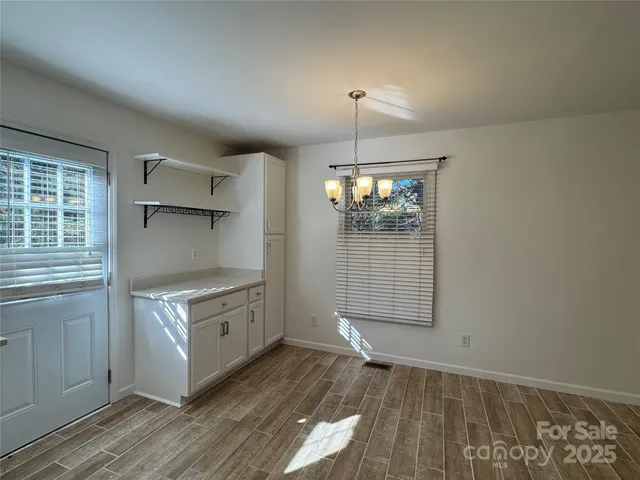a view of a kitchen with a sink dishwasher and wooden floor