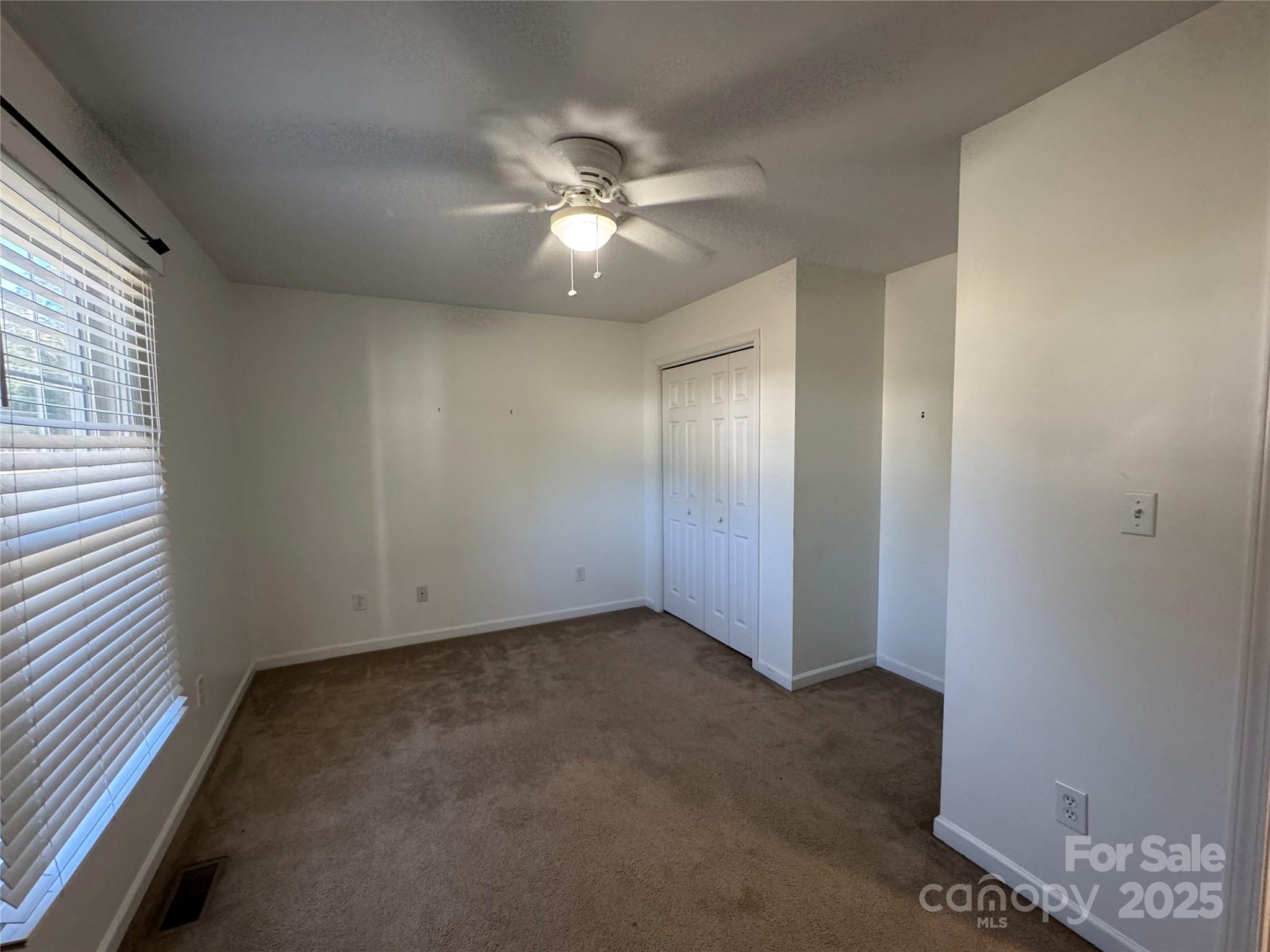 314 East Louisiana Avenue Bessemer City, NC 28016 - Photo 10 of 15 an empty room with windows and fan