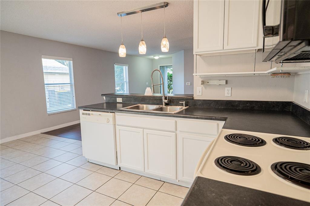 1836 Ridge Valley Street Clermont, FL 34711 - Photo 18 of 45 a kitchen with a sink a stove and cabinets