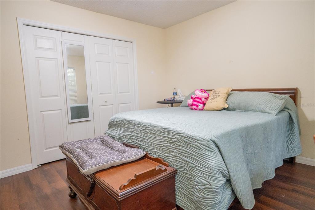 1836 Ridge Valley Street Clermont, FL 34711 - Photo 29 of 45 a bedroom with a bed and wooden floor
