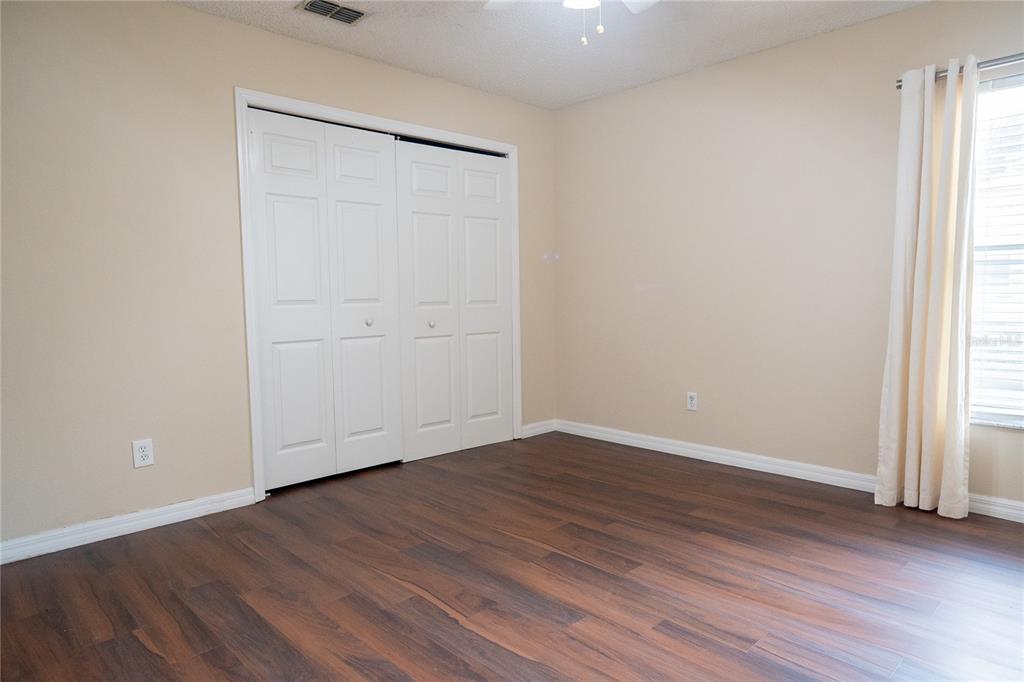 1836 Ridge Valley Street Clermont, FL 34711 - Photo 31 of 45 an empty room with wooden floor and window