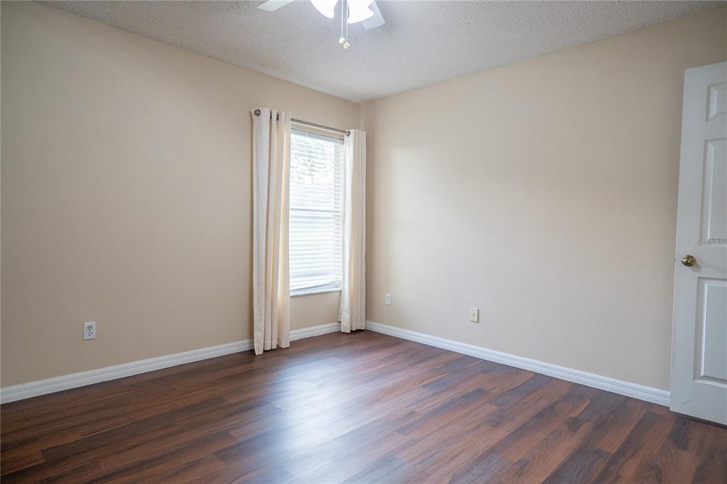 1836 Ridge Valley Street Clermont, FL 34711 - Photo 32 of 45 an empty room with wooden floor and windows
