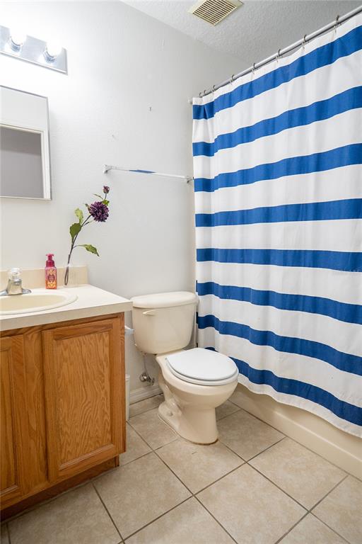 1836 Ridge Valley Street Clermont, FL 34711 - Photo 35 of 45 a bathroom with a sink a toilet a mirror and shower curtain