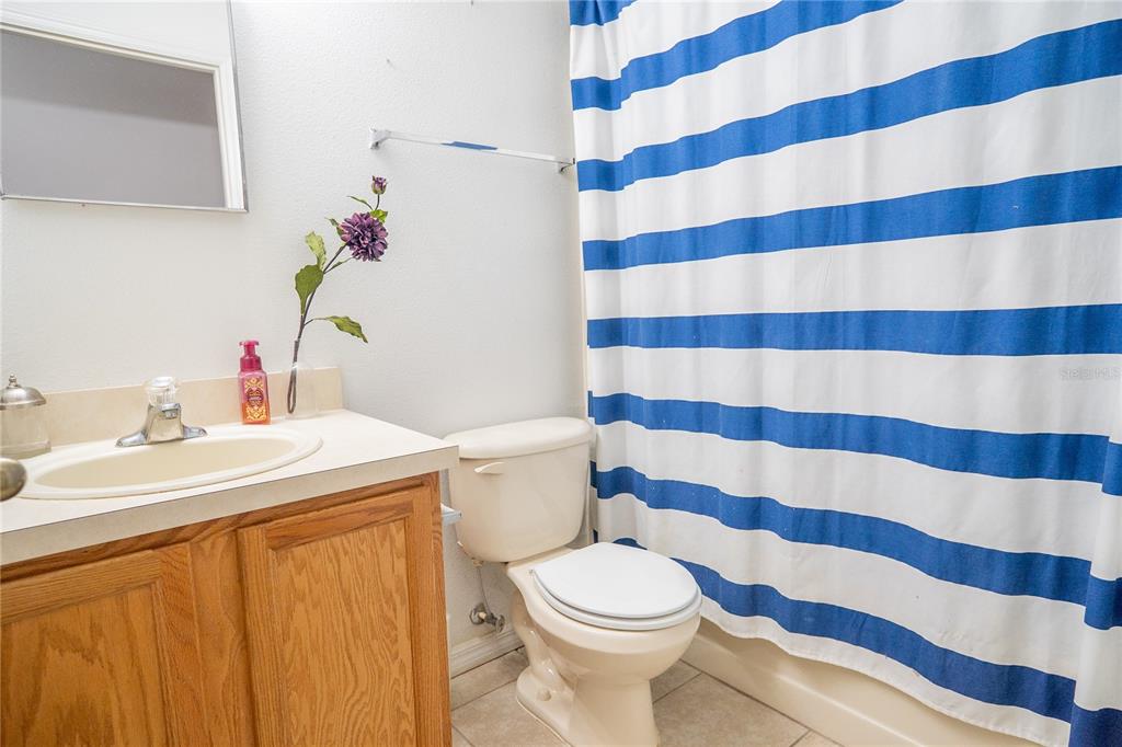 1836 Ridge Valley Street Clermont, FL 34711 - Photo 36 of 45 a bathroom with a sink toilet and a mirror