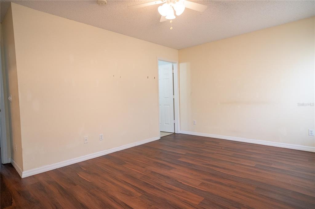 1836 Ridge Valley Street Clermont, FL 34711 - Photo 41 of 45 an empty room with wooden floor and windows