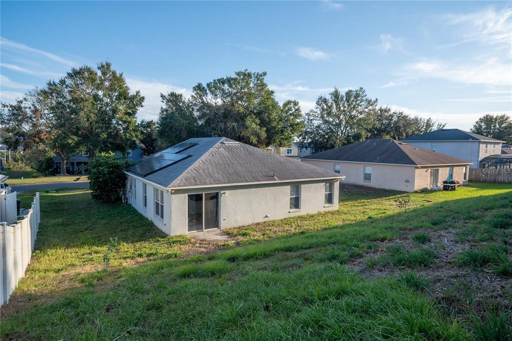 1836 Ridge Valley Street Clermont, FL 34711 - Photo 7 of 45 a house that is sitting in the grass with large windows and a big yard