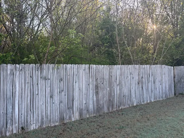 a view of outdoor space with wooden fence