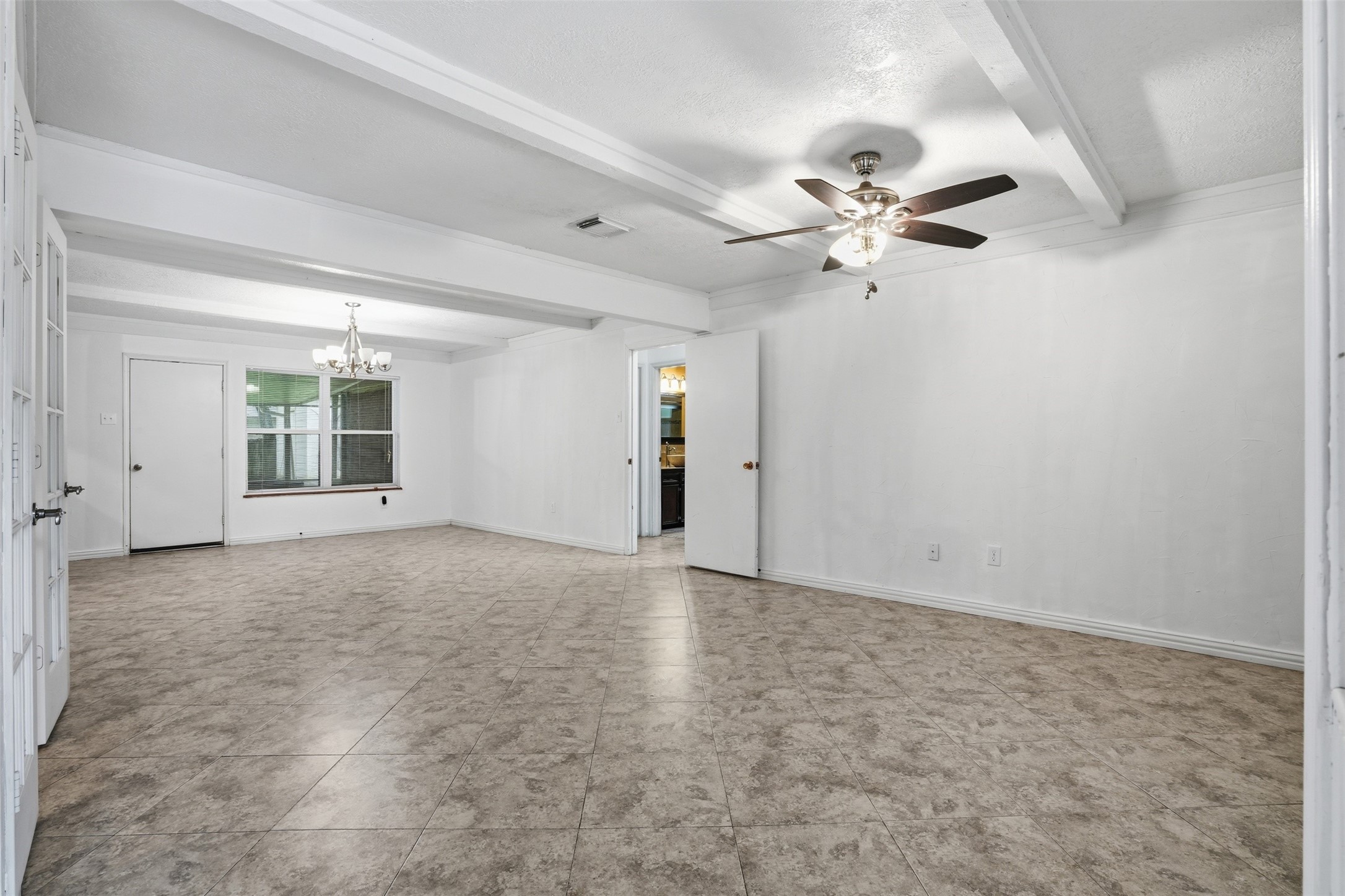 2605 Burke Road Pasadena, TX 77502 - Photo 12 of 29 an empty room with a ceiling fan and a window