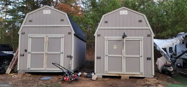 a view of backyard with cabin