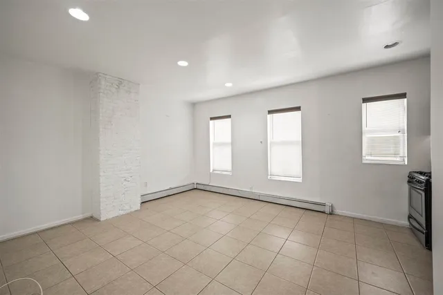 a kitchen with stainless steel appliances granite countertop a stove refrigerator and cabinets