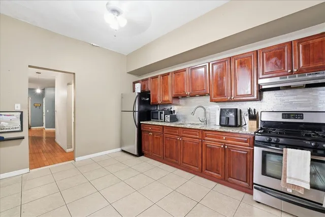 a kitchen with stainless steel appliances granite countertop a refrigerator sink and cabinets