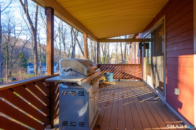 a view of balcony with wooden floor and outdoor seating