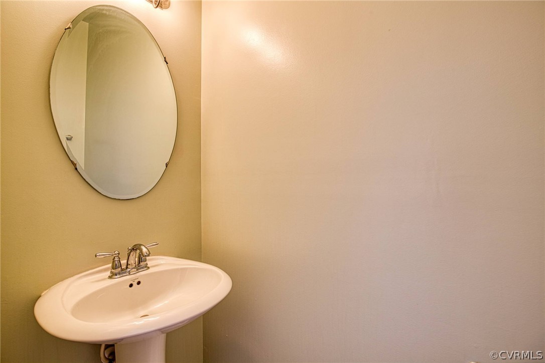 7292 Hardtack Road Mechanicsville, VA 23116 - Photo 4 of 34 a bathroom with a sink and a mirror