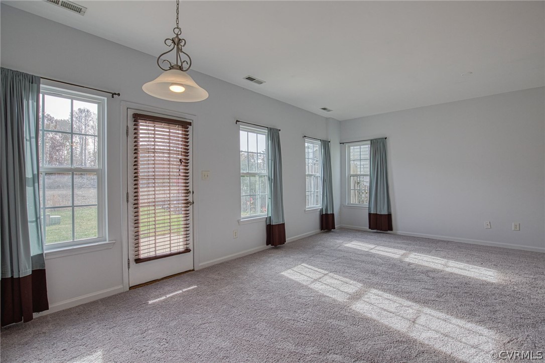 7292 Hardtack Road Mechanicsville, VA 23116 - Photo 9 of 34 an empty room with windows and chandelier