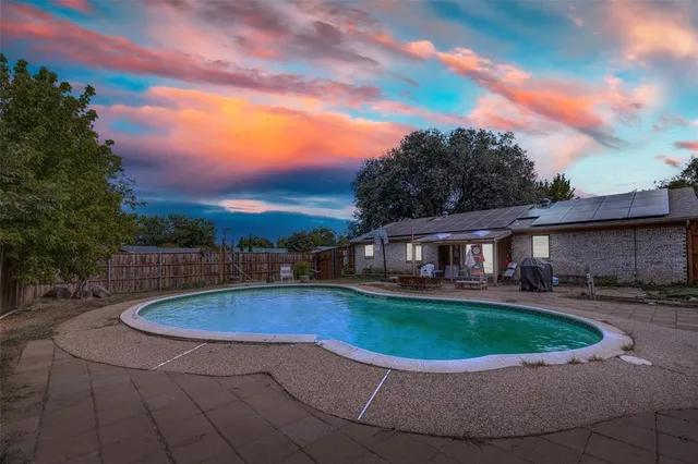 a view of a swimming pool with a patio