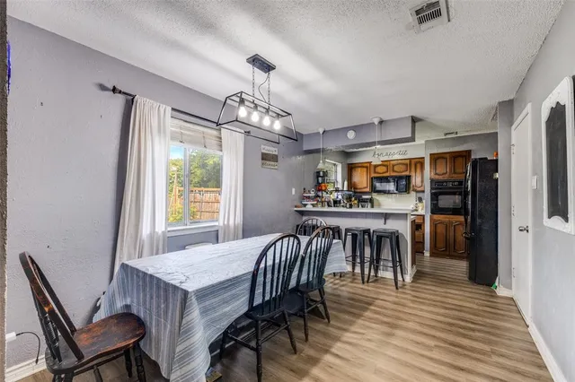 a view of a dining room with furniture and window