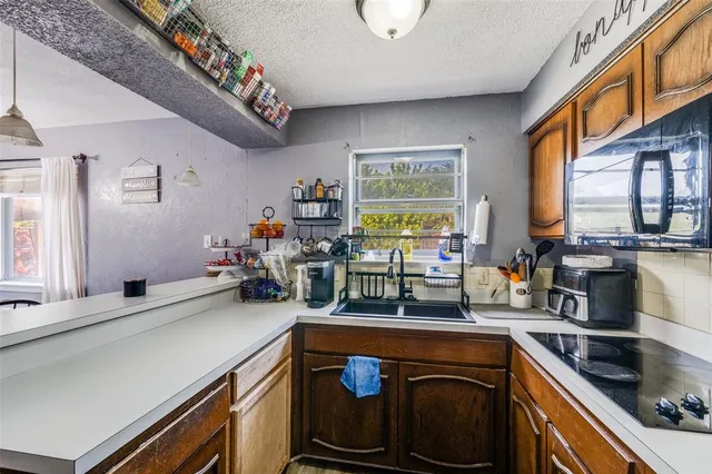 a kitchen with a sink stove and cabinets