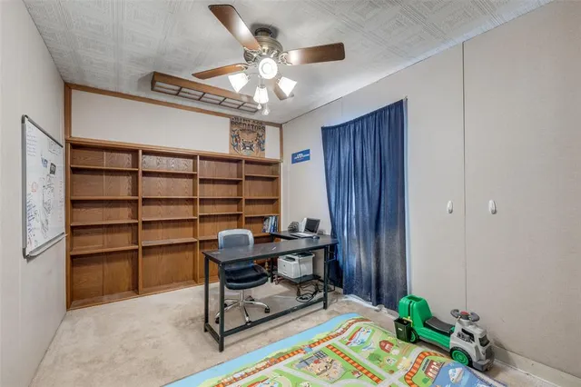 a view of a workspace with furniture and a window